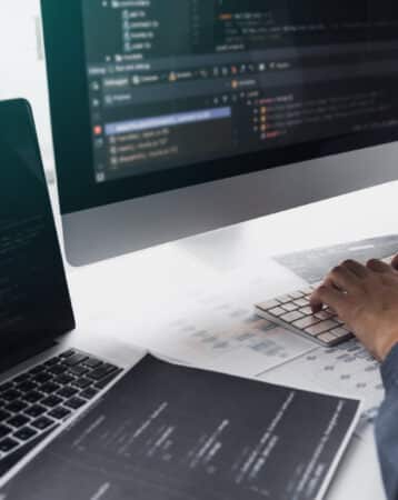 Developing programming and coding technologies working in a software engineers developing applications together in office.
